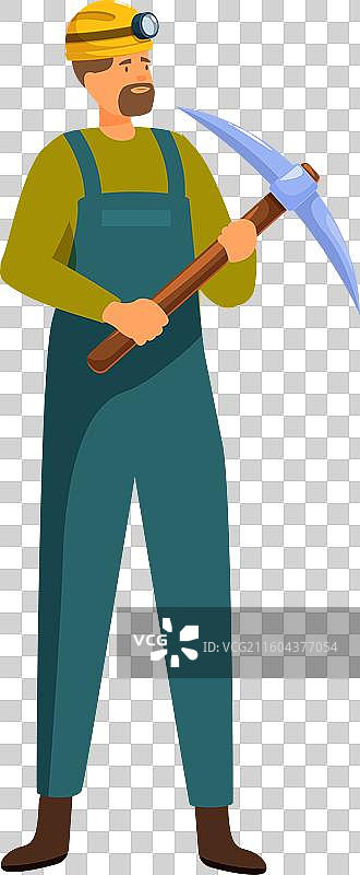 一位戴着头盔、手持矿镐站立的煤矿工人图片素材