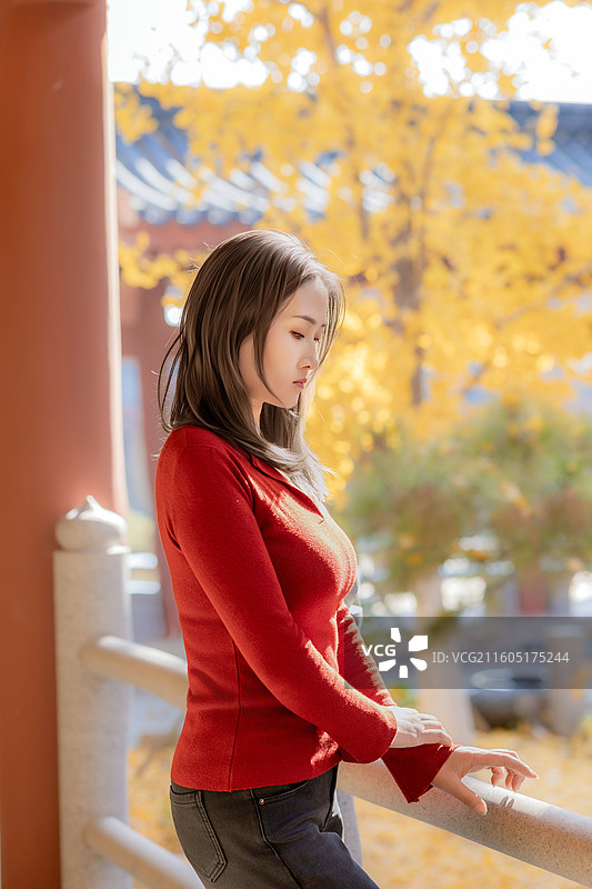 红色针织衫女子与古建筑寺庙图片素材