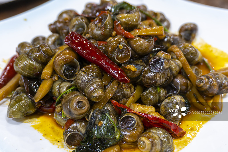 广西美食炒田螺图片素材