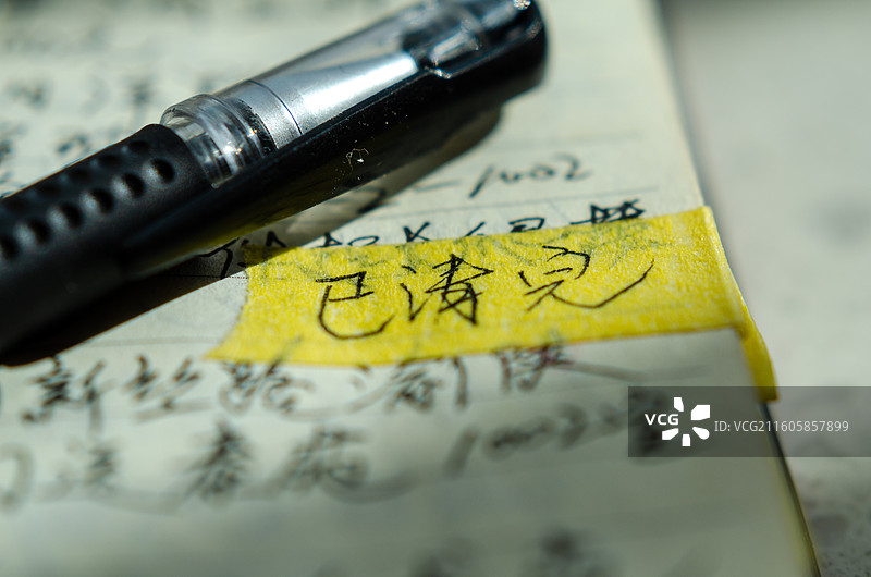 中性笔置于已清完的手写笔记与便签纸上图片素材