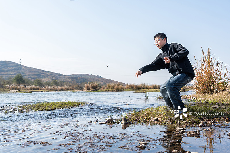 男子在河边户外玩耍图片素材