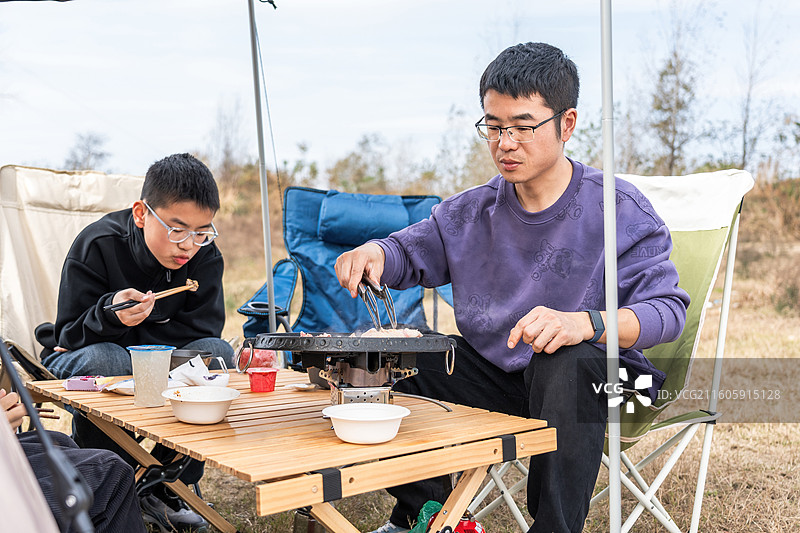 户外露营中人们烹饪用餐图片素材
