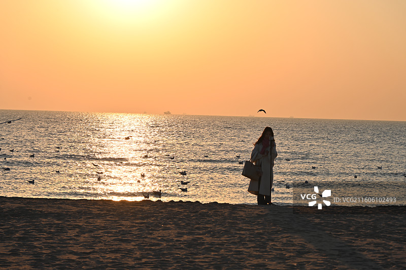 秦皇岛昌黎县阿那亚黄金海岸日出时分人物剪影图片素材