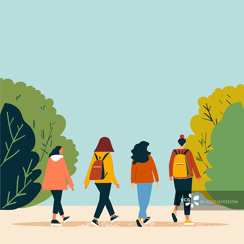 一群来自不同背景的朋友在秋日的公园里悠闲散步图片素材