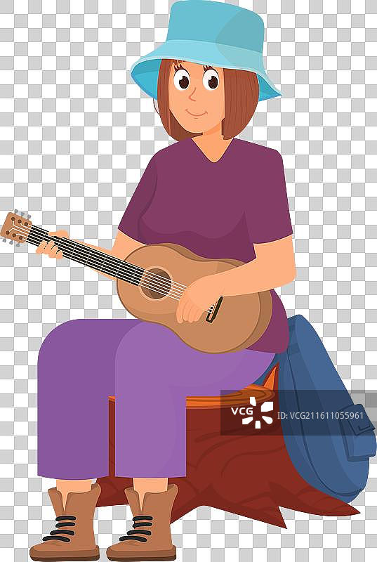 女人在户外露营时弹吉他图片素材