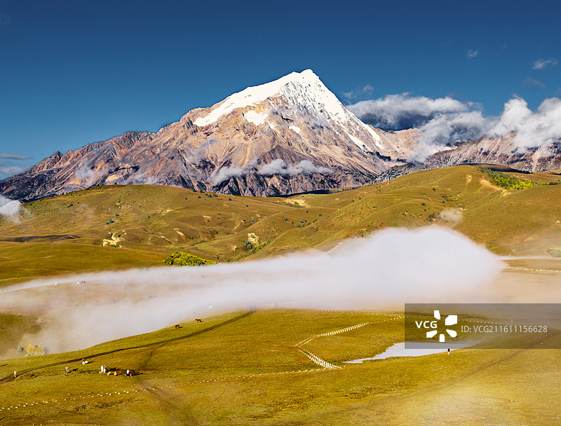 然日卡草原平流雾中的格聂雪山主峰图片素材