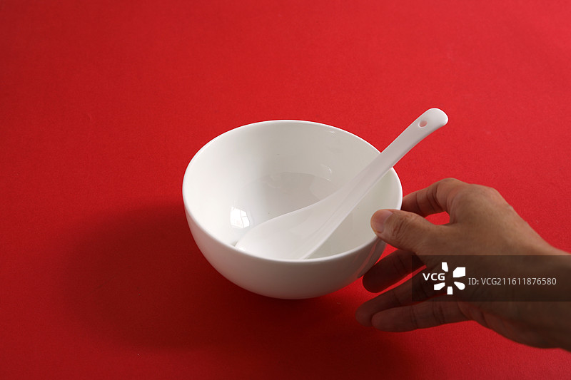 红色桌面上摆放着白色的餐具瓷器碗盘子碟子图片素材