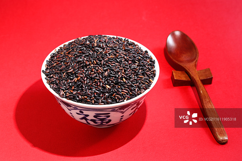 红色桌面上的一碗丰收农产品粮食大米黑米图片素材