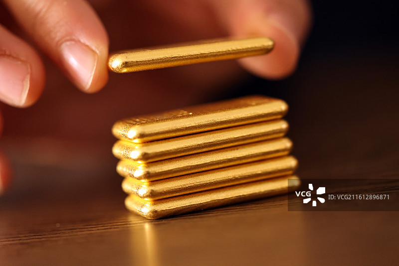 金条放在堆叠的钱币上图片素材