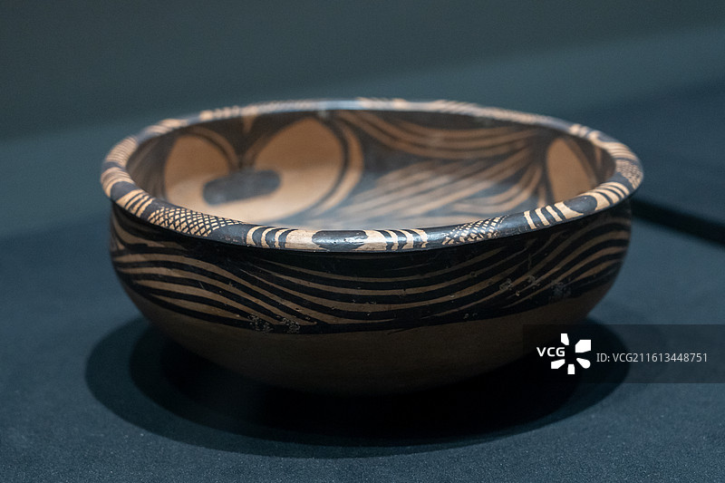 甘肃省博物馆藏，马家窑类型变体人面纹旋纹彩陶盆图片素材