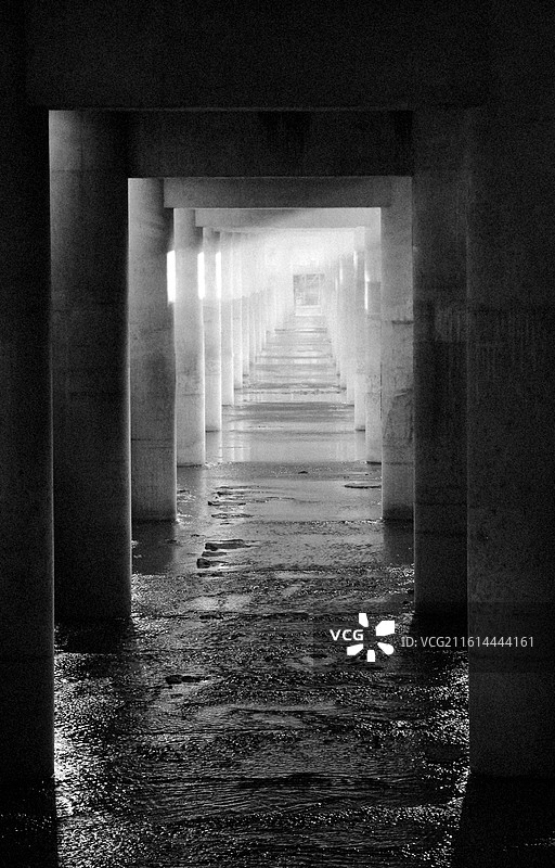 黑与白的浸没：孤独是廊柱的影子，漫过积水，伸向光的方向。图片素材