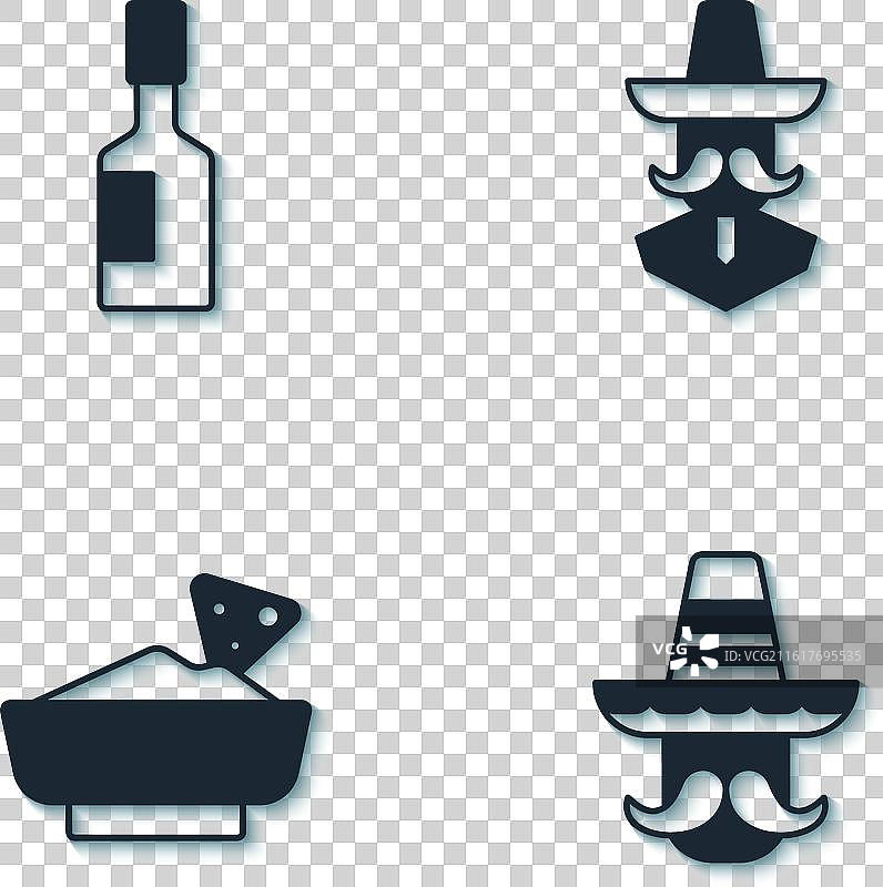 墨西哥男人戴着墨西哥帽，吃着玉米片，旁边放着塔巴斯科辣椒酱图片素材