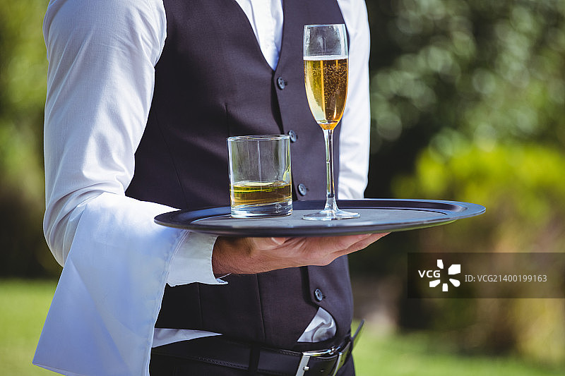 英俊的男服务员托着托盘图片素材
