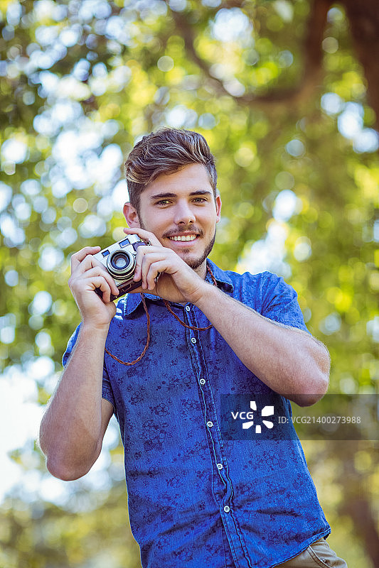 时尚男士在夏日拿着复古相机图片素材