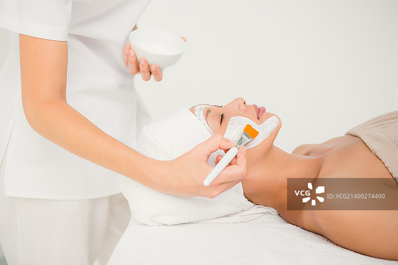 在水疗中心接受治疗的迷人女性侧视图图片素材