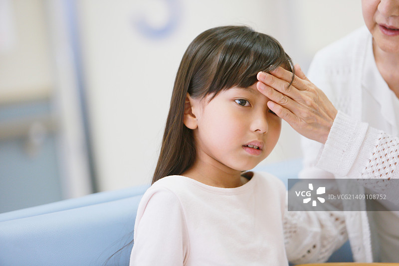 在医院与祖母在一起的生病日本年轻女孩图片素材