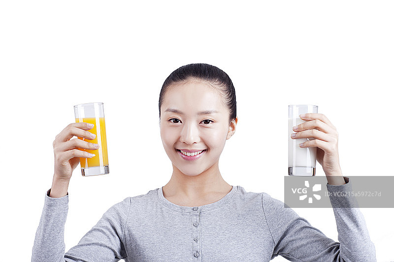 休闲女士手握橙汁和牛奶图片素材