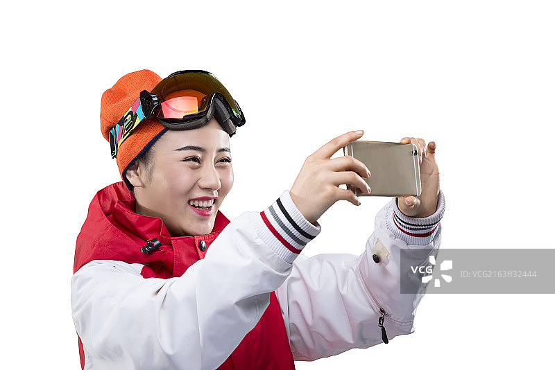 Young female skier making selfie on smartphone图片素材
