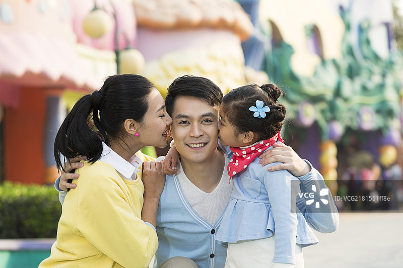 快乐的一家三口去游乐园玩图片素材