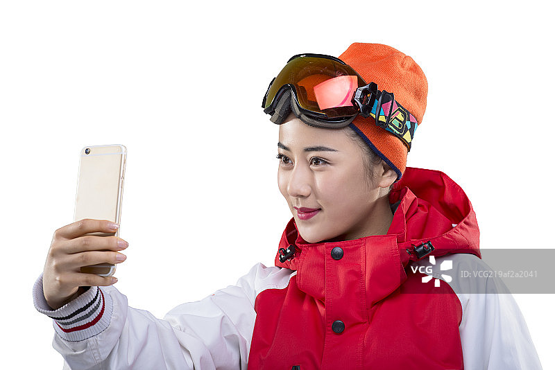 Young female skier making selfie on smartphone图片素材