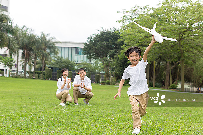 快乐的一家人在公园玩飞机模型图片素材