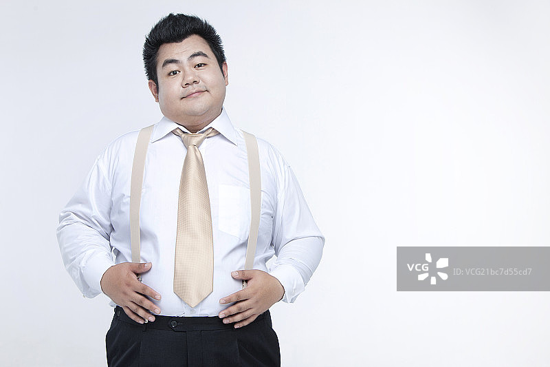 白色背景前的胖白领图片素材