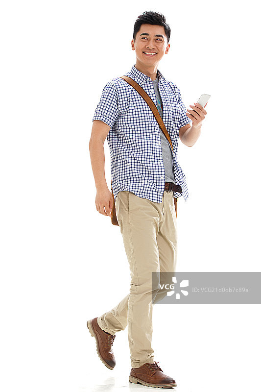 一个年轻的大学男生拿着手机图片素材