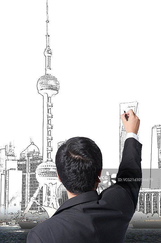 青年商务男人勾画城市蓝图图片素材