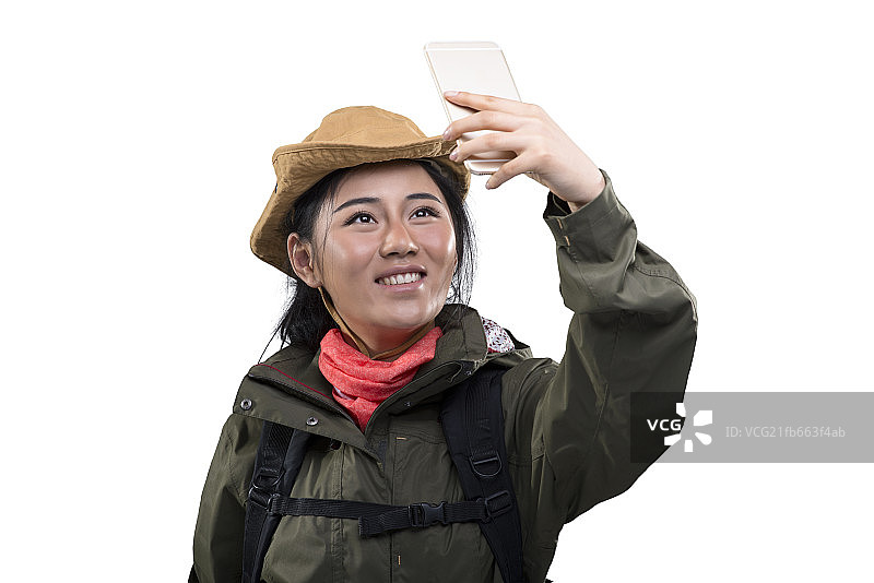 Young female mountain climber making selfie on smartphone图片素材