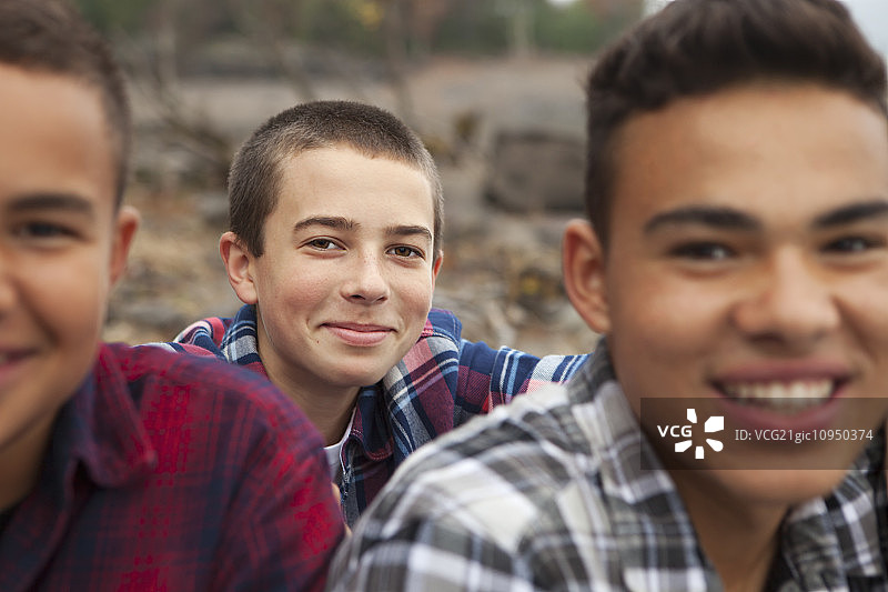 在阿肖坎湖畔游玩的一天：岸边的三个男孩图片素材