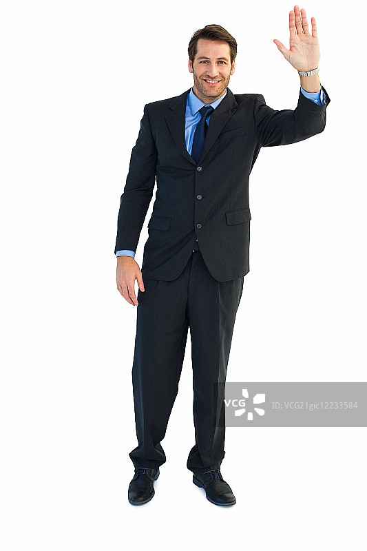 在白色背景下敬礼的微笑男商人图片素材