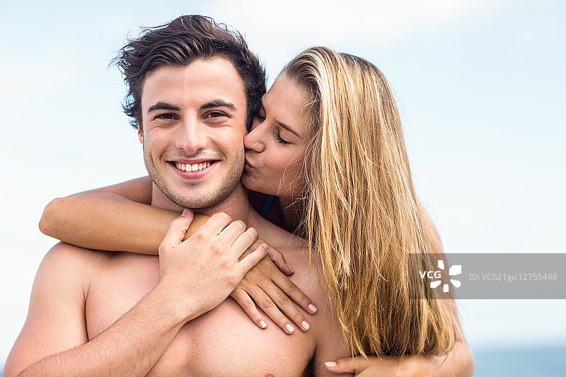 英俊男人在海滩与女友亲吻图片素材