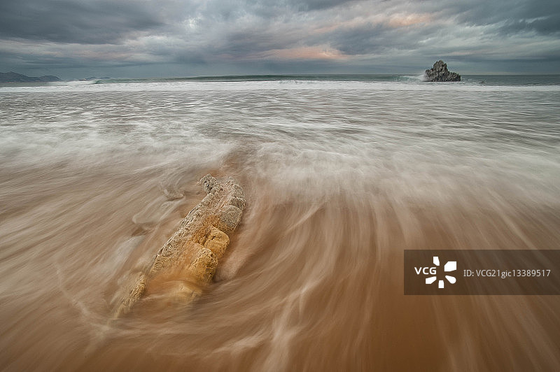 黎明时多云天空下的海浪，西班牙巴斯克地区图片素材