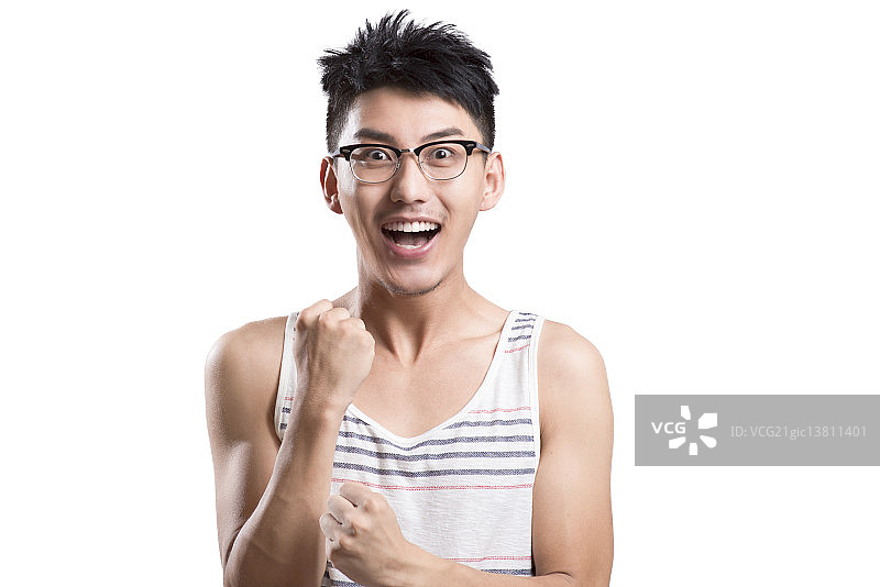 Portrait of young man cheering图片素材