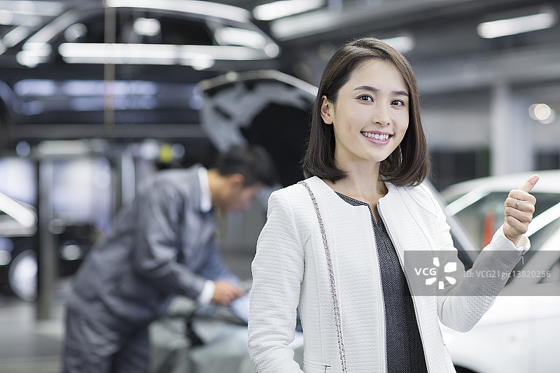 女车主在汽车修理店图片素材