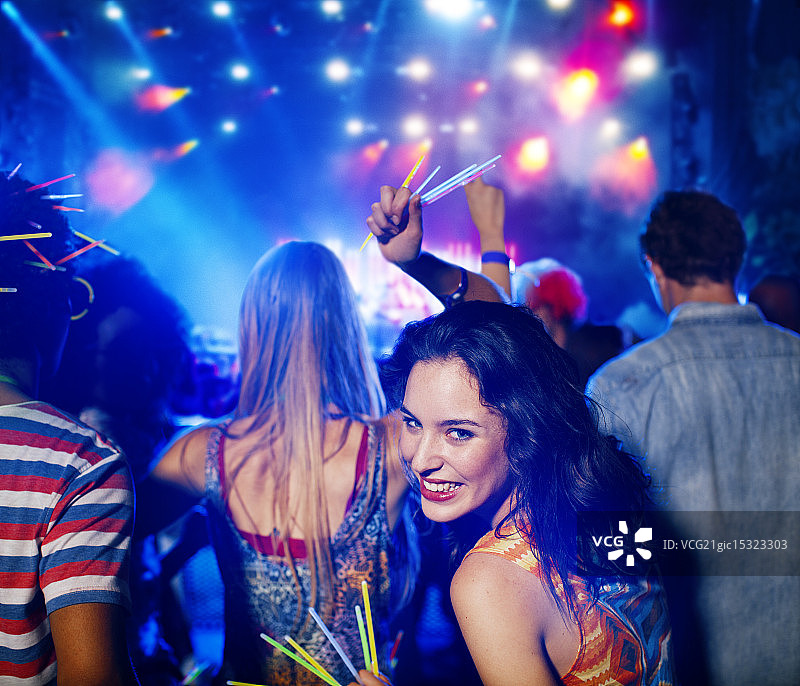 在音乐节上拿着荧光棒的女人图片素材