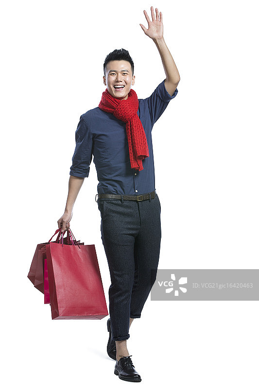 青年男子拿着购物袋图片素材