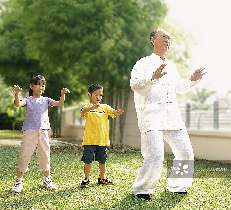孩子们在爷爷身后练习太极图片素材
