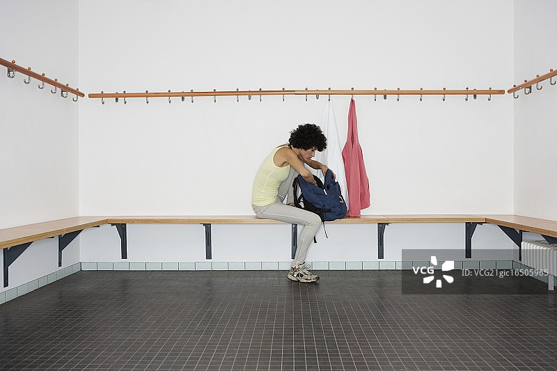 在更衣室里翻看背包的女人图片素材