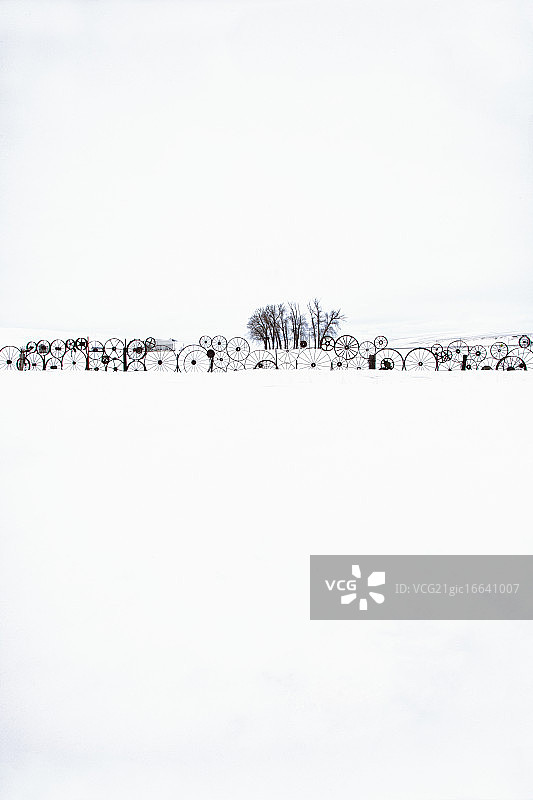 雪地上的旧铁轮围栏图片素材