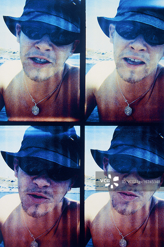 戴着软帽在海边的年轻男人（四折）图片素材