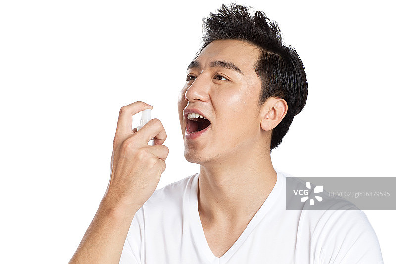 青年男人在喷口腔清新剂图片素材
