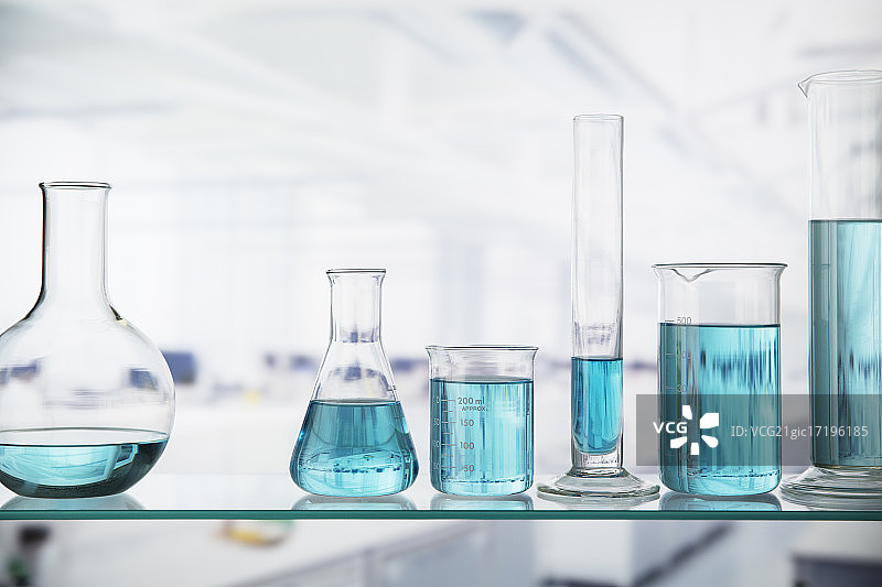 实验室架子上装有溶液的烧杯特写图片素材