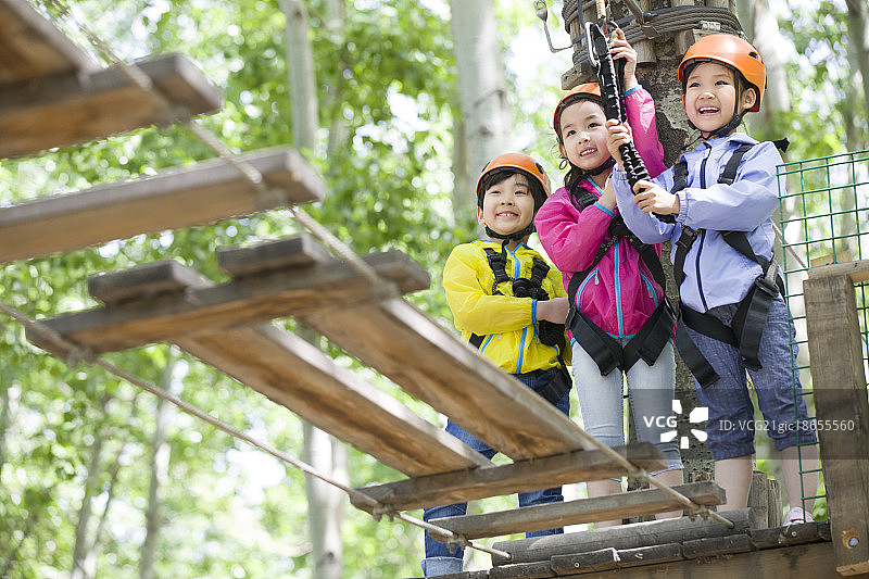 快乐的孩子们挑战树上穿越项目图片素材