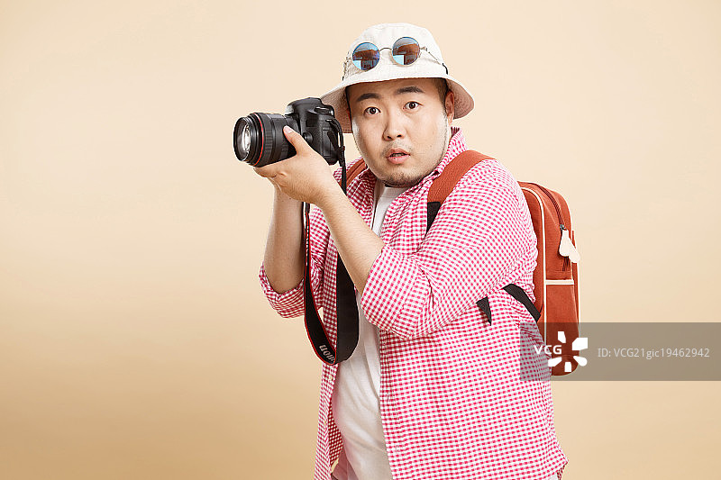 肥胖的青年男人拿着相机图片素材