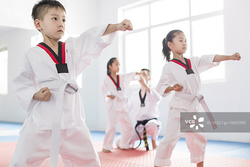 年轻教练教儿童跆拳道图片素材