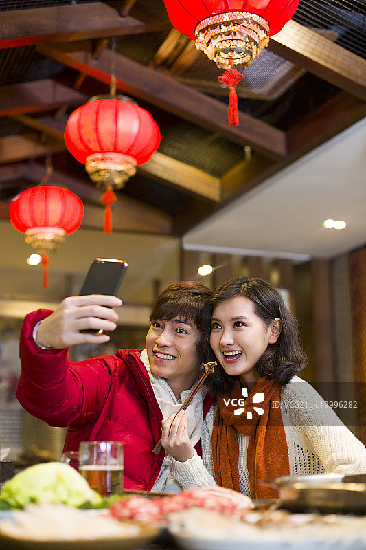 年轻情侣用手机自拍图片素材