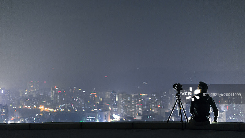 摄影师在城市高点拍摄图片素材