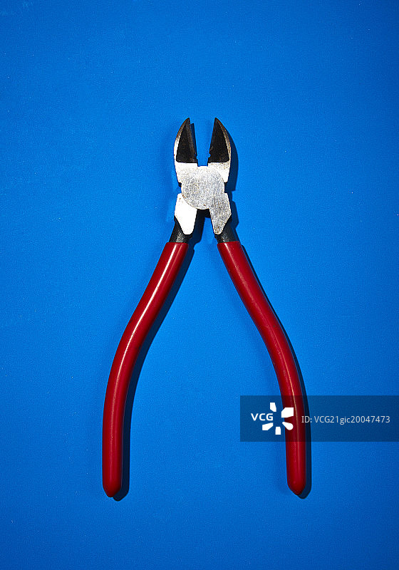 蓝色背景上的钢丝钳图片素材
