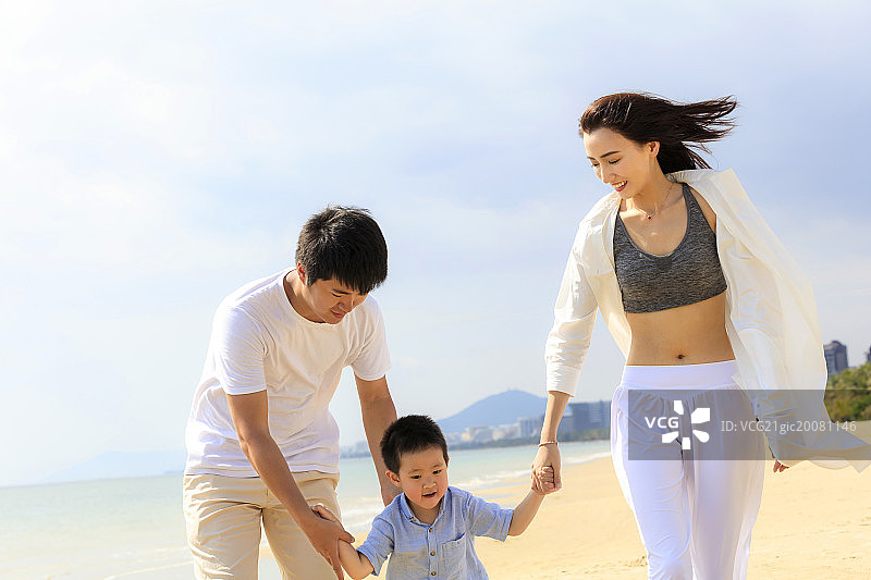 一家三口在海滩散步图片素材